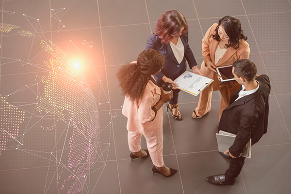 Image shows a team of collaborators discussing notes